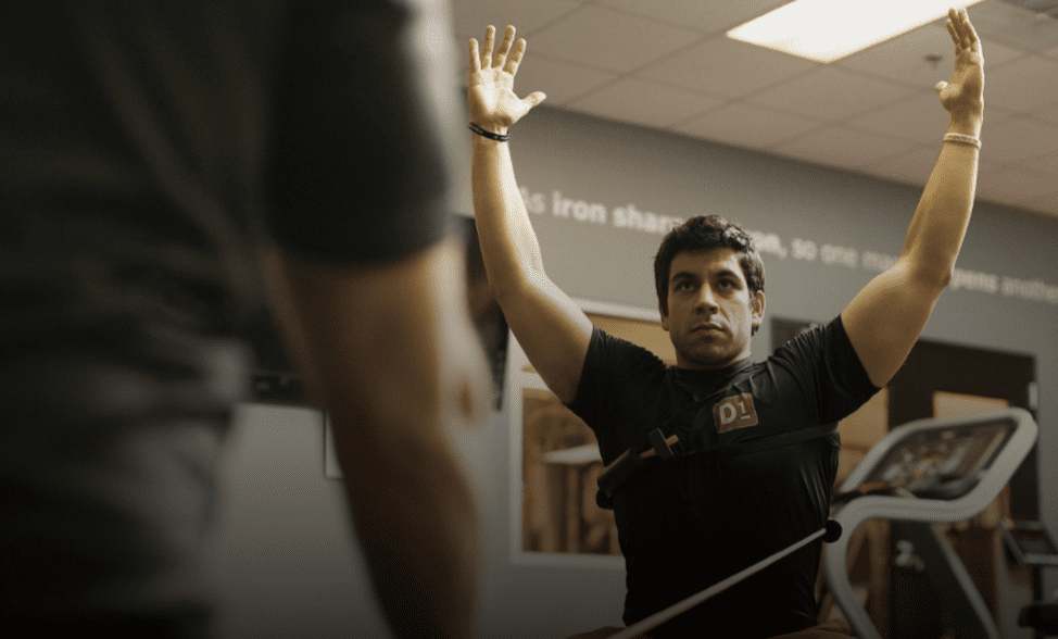 Man training with resistance band raising hands
