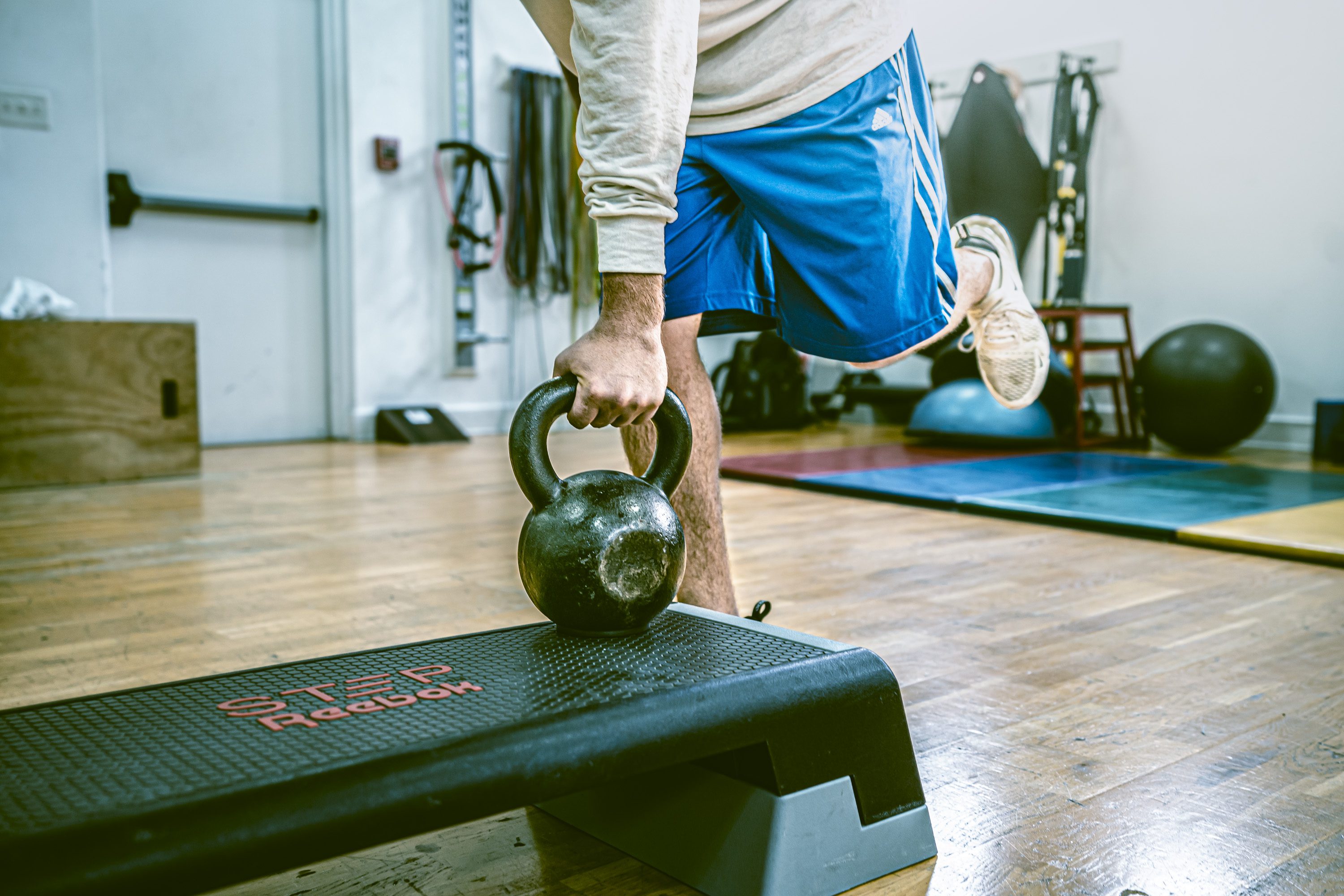 Person performing single-arm kettlebell lunge