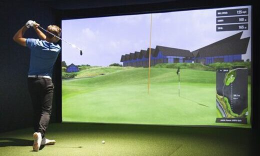 Golfer playing indoors on a golf simulator